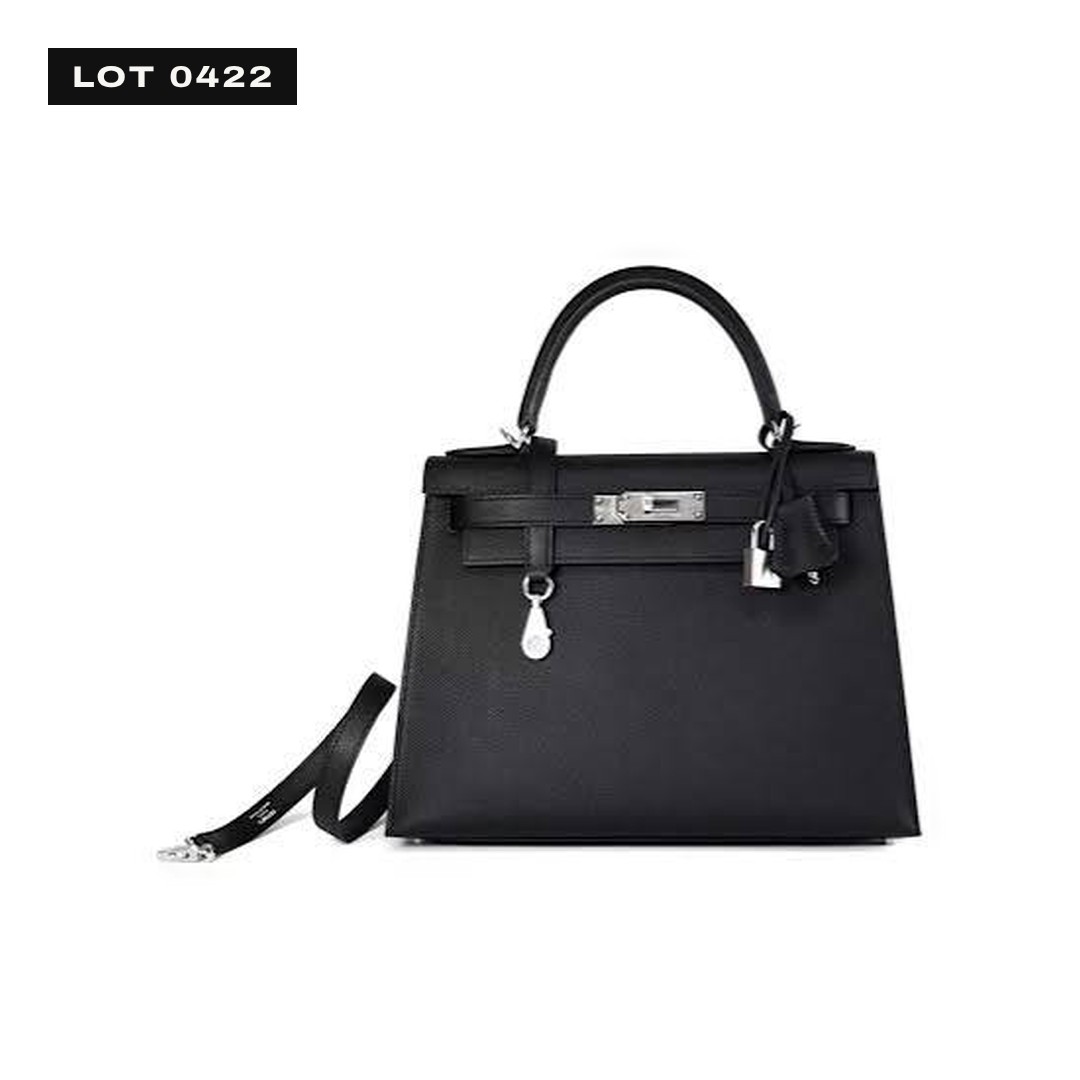 Drawing of a black leather top-handle bag with gold hardware, a strap closure and a leather key bell.