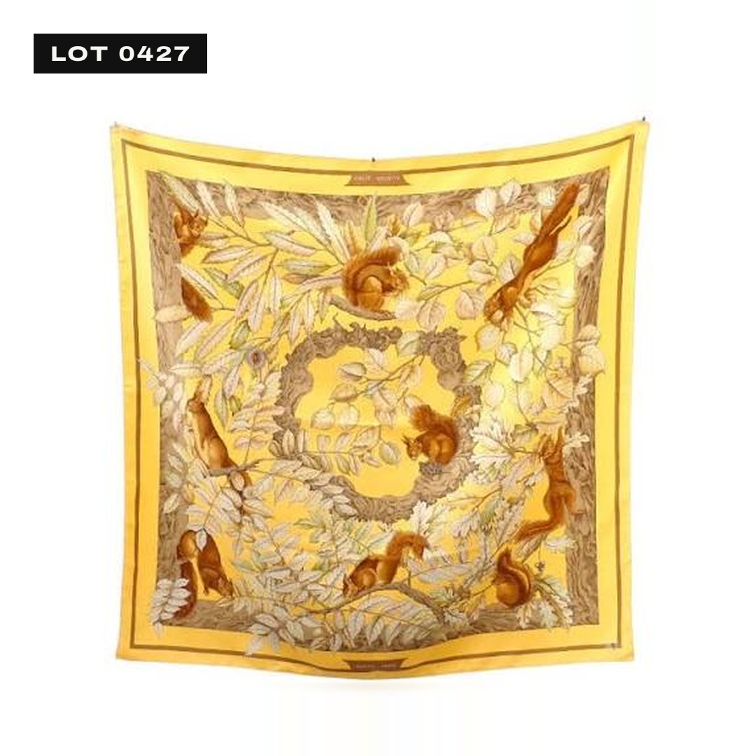 Drawing of a square printed silk scarf with an oxblood border and a green and gold medallion.